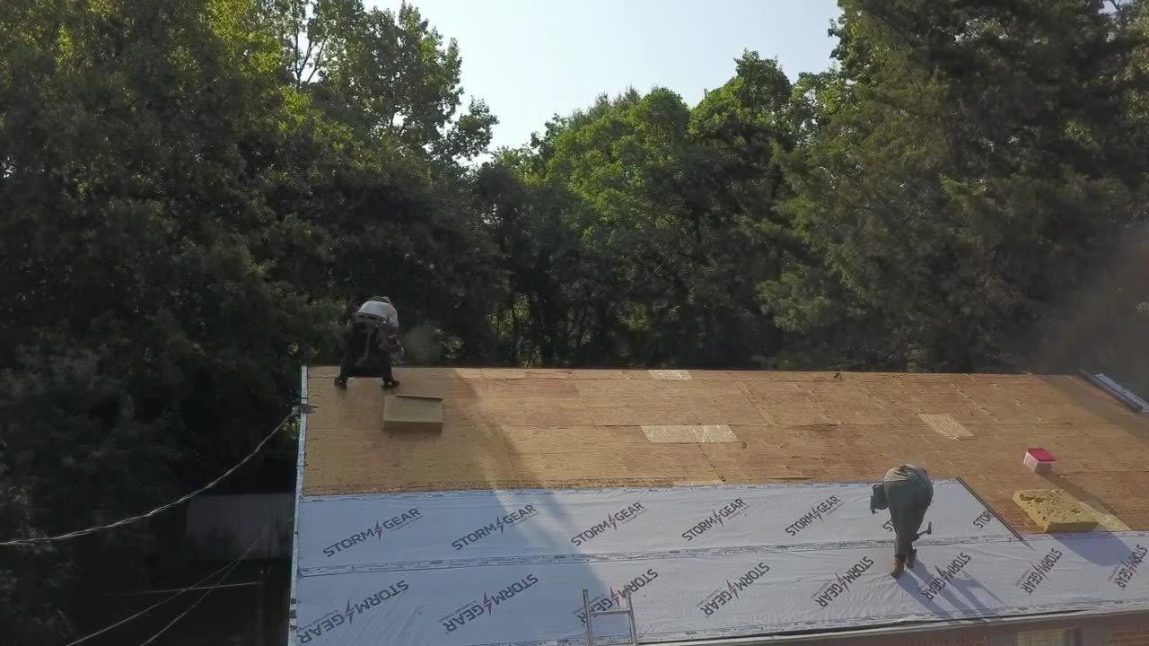 Crew installing decking and underlayment