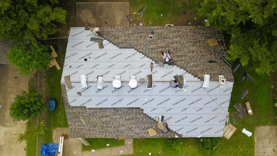 Roof mid-replacement with underlayment, aerial view